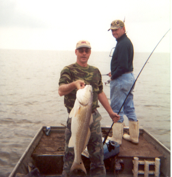 Joe's older brother Dick watches as I display another monster redfish.
